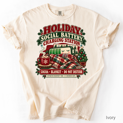 Holiday Social Battery Charging Station funny Christmas shirt with a sleepy battery, cocoa, plaid blanket and Christmas tree